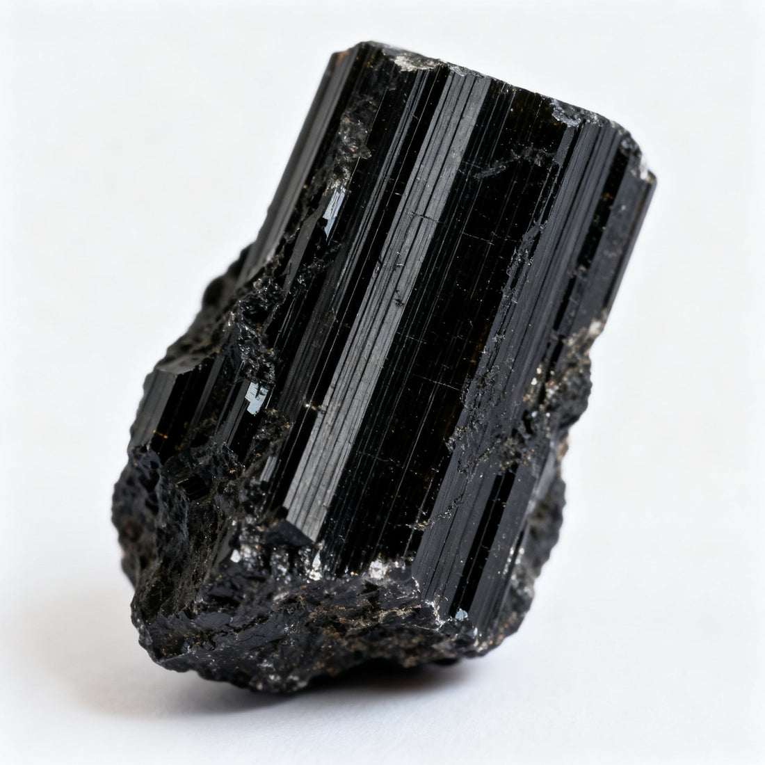 Raw black tourmaline (schorl) crystal showing prismatic striations