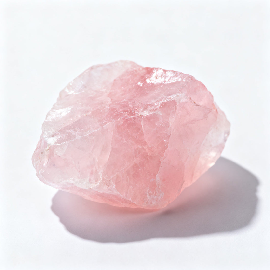 Raw rose quartz stone with its characteristic cloudy pink translucence
