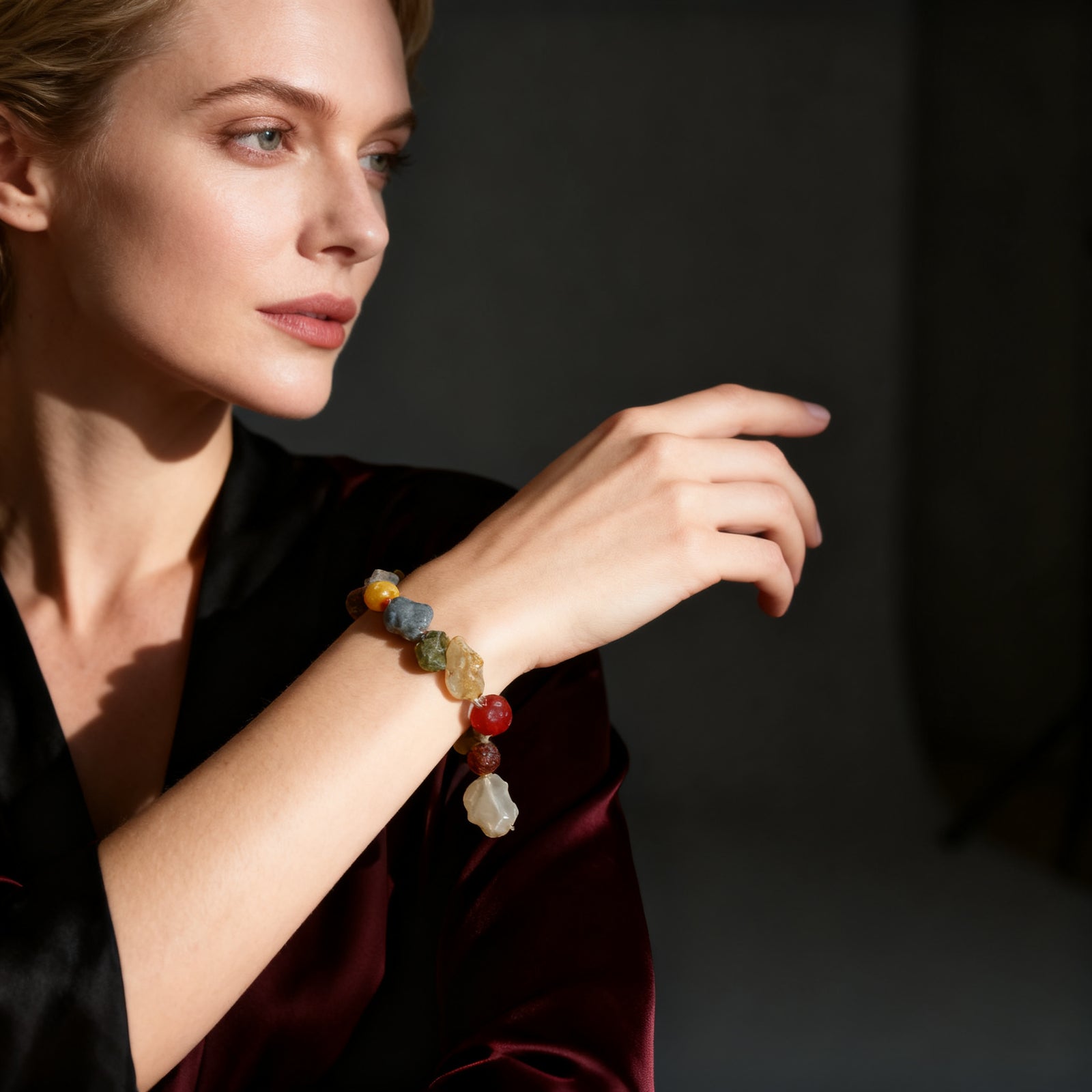 Western female model wearing the natural Alxa agate bracelet, dark moody tone