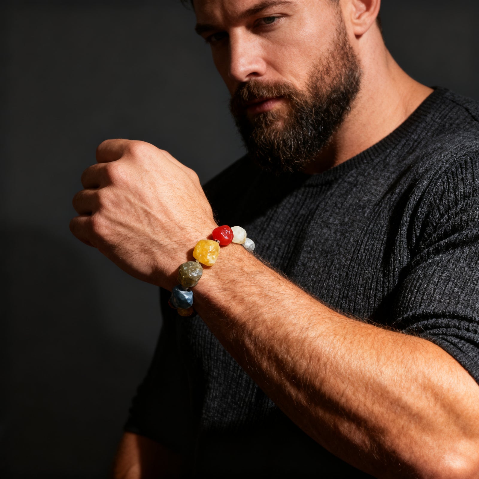 Western bearded male model wearing the natural Alxa agate bracelet, dark moody tone