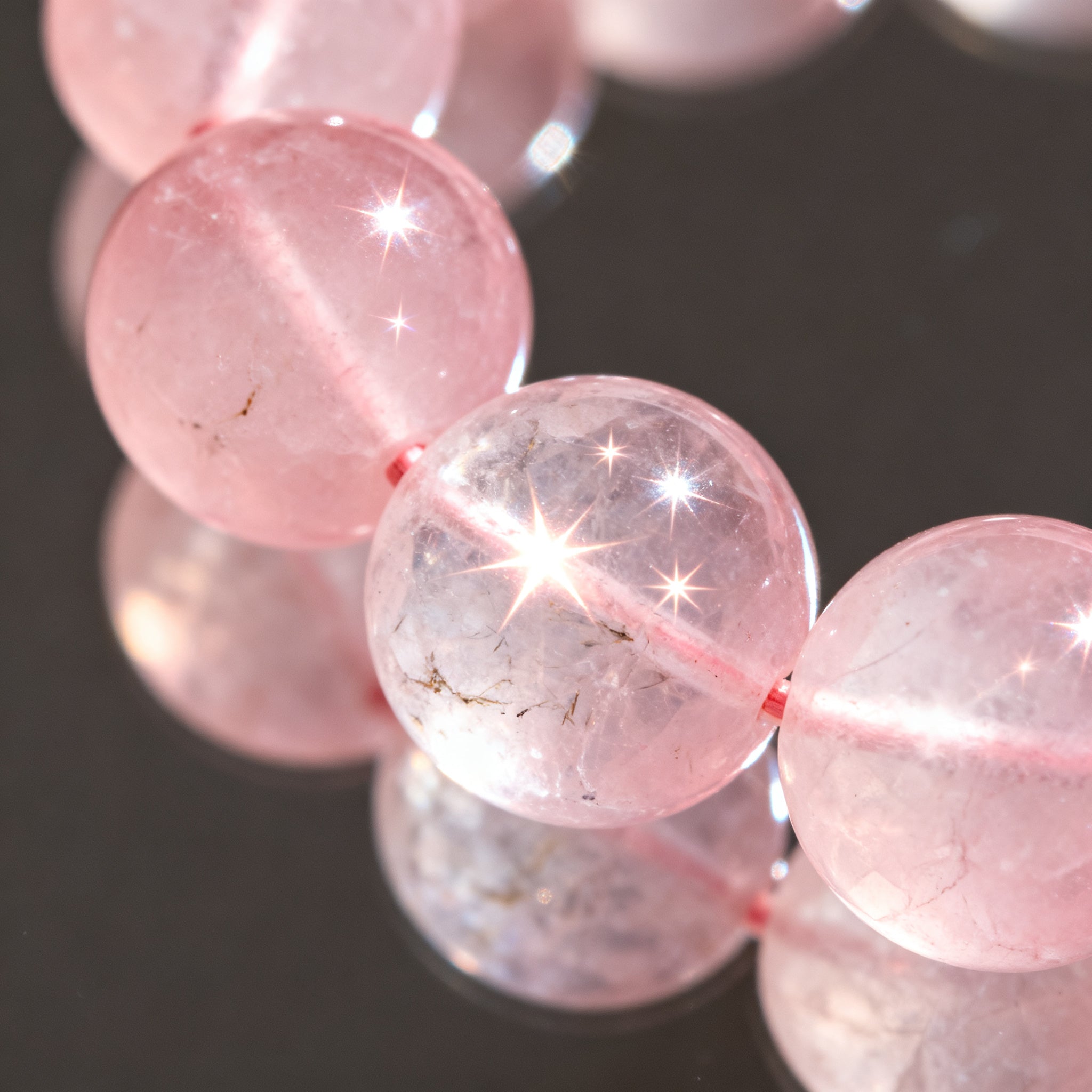 Closeup detail of soft pink Rose Quartz crystal beads - translucent texture